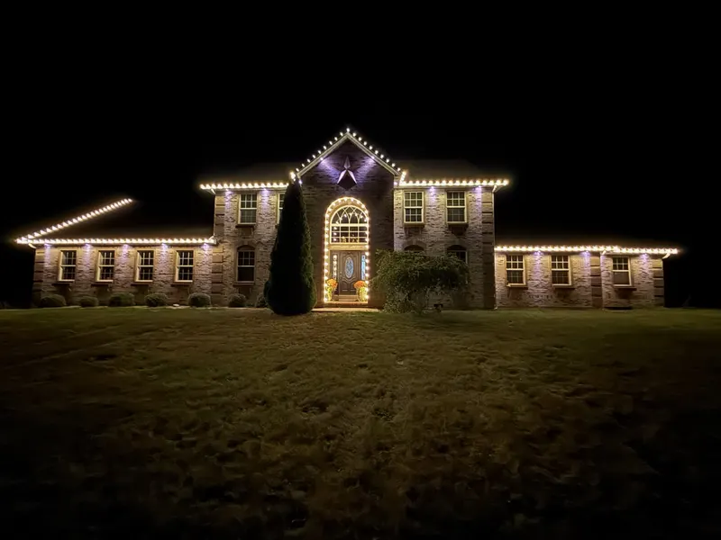 Christmas lights on a brick home, taken down and stored by Elite in January